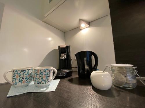 a table with two coffee mugs on top of it at Worker Space Kleve in Kleve