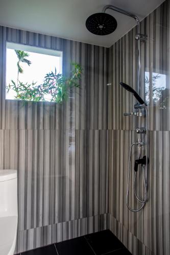a bathroom with a shower with a shower curtain at Naiharn Pool Villa Number 5 in Rawai Beach