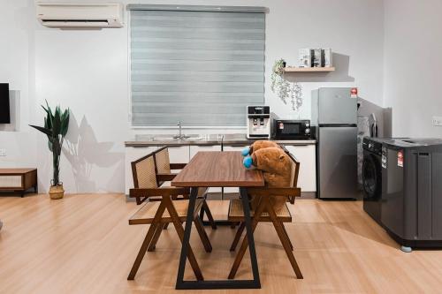 a kitchen with a table with a stuffed animal on it at Taiping Rain Suite Homestay near Lake Garden with Netflix WiFi in Taiping