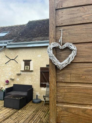 a wooden door with a heart hanging on it at EpLABONNE in Channay-sur-Lathan