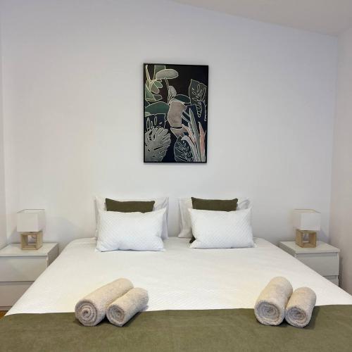 a bedroom with a bed with three pillows on it at Apartments VMadeira in Funchal