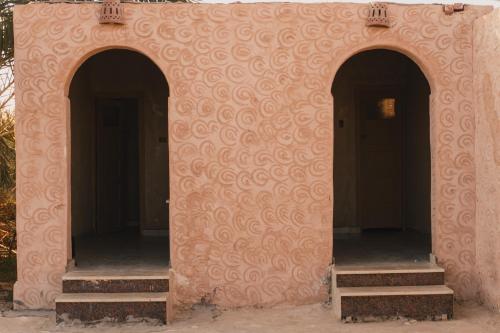 a building with two doors and two stairs in it at Stamps Ayur Siwa in Siwa