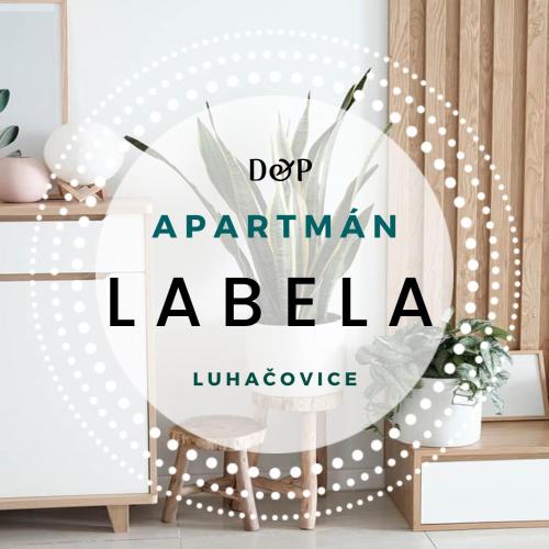 a room with a chair and a sign that says dear apartment lailli at Labela Luhačovice Apartment in Luhačovice