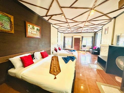 a hotel room with two beds in a room at Big Family Bungalow Near Swiming Pool in Ko Chang