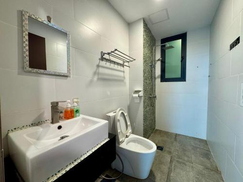 a white bathroom with a sink and a toilet at Vivacity Cozy Jazz4 2R1B wNetflix, 7pax YPM1202 in Kuching