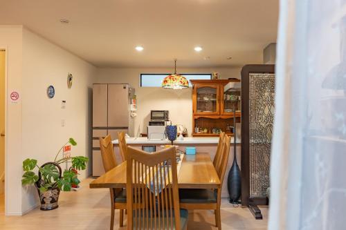 a kitchen and dining room with a table and chairs at 3 minutes walk to the station, direct to Ikebukuro, two-story house with a garden in Tokyo