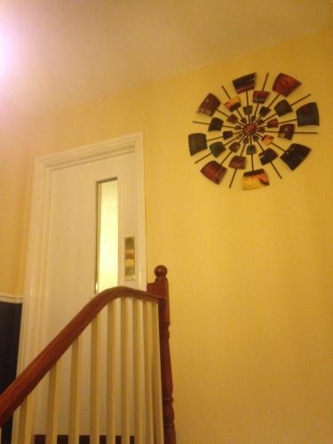 a clock on a wall next to a staircase at Lynebank House Hotel, Bed & Breakfast in Carlisle