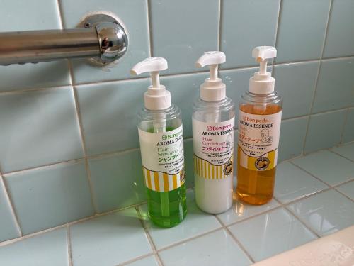 three bottles of cleaning products sitting on a counter at サンライズハウス in Osaka