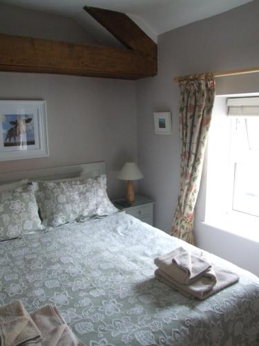 a bedroom with a bed and a window at Inglenook in Kinsale
