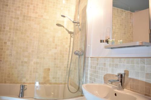 a bathroom with a shower and a sink at Davenford Cotswold Gardens in Stow on the Wold