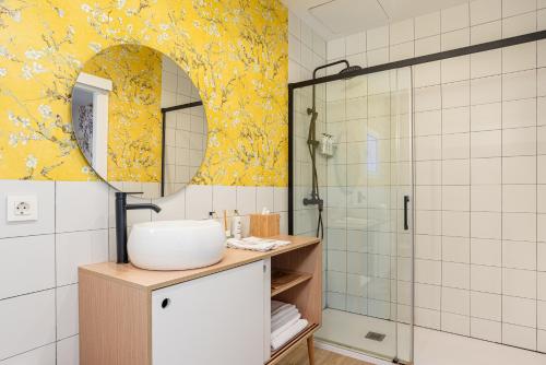 a bathroom with a sink and a shower with a mirror at Art Suites by Casa de Indias in El Puerto de Santa María