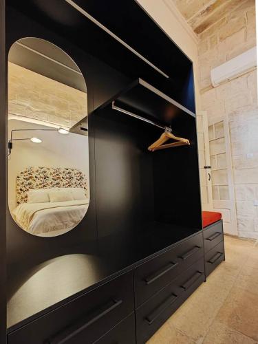 a bedroom with a large mirror on the wall at Harbour Heights in Birgu