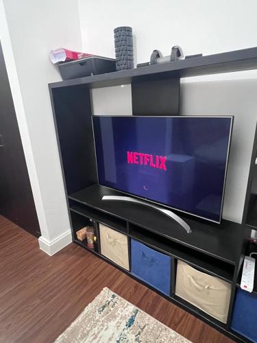a flat screen tv sitting on a black entertainment center at Luxurious Lake view Private Room in Abu Dhabi