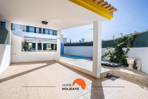 a villa with a view of the courtyard of a house at #039 Family Private Pool AC in Vale de Pedras