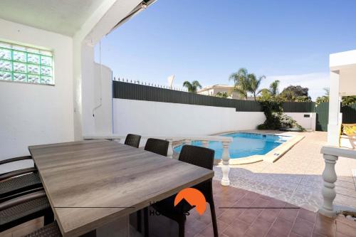 a dining room with a table and a swimming pool at #039 Family Private Pool AC in Vale de Pedras