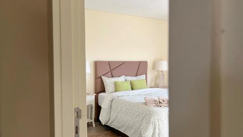 a bedroom with a bed with a bow on it at Casa d'Avó in Avanca