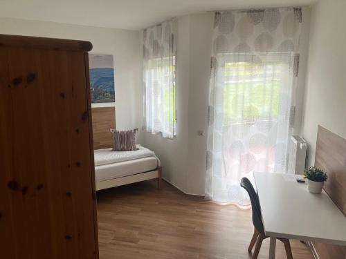 a small room with a table and a window at Gästehaus Windhagen in Windhagen