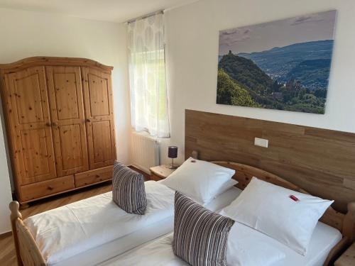 a bedroom with two beds and a painting on the wall at Gästehaus Windhagen in Windhagen