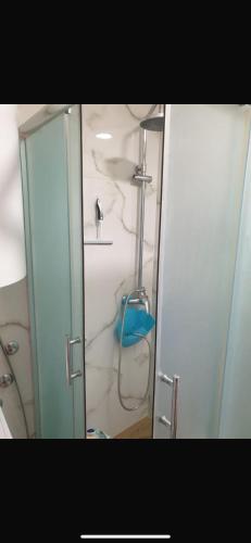 a shower in a bathroom with a glass door at Apartman- Ledine in Ledine