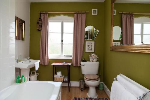 a bathroom with a tub and a toilet and a sink at Lower Buckton Country Living Big House near Ludlow 6 bedrooms sleep 12 in Leintwardine