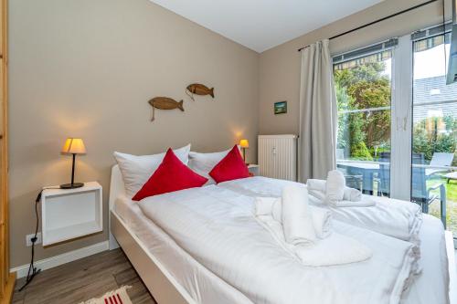 En eller flere senge i et værelse på Treibholz Appartment