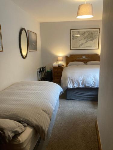 a hotel room with two beds and a mirror at Ashes Seafood Restaurant Accommodation in Dingle