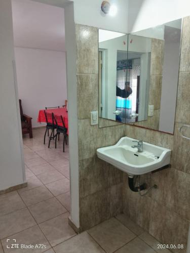 a bathroom with a sink and a mirror at DEPTOS VM Complejo x 3 in Villa María