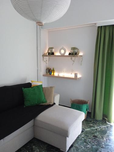 a living room with a couch and green curtains at Mylos House in Tríkala