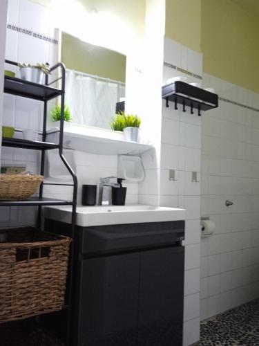 a bathroom with a sink and a mirror at Mylos House in Tríkala