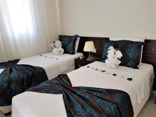 two beds with stuffed animals on them in a room at Villa Oludeniz Heights in Fethiye