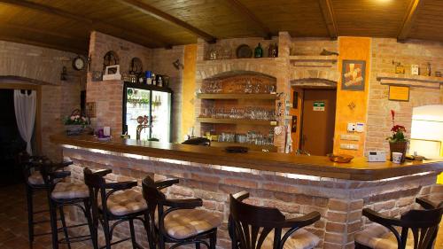 a bar in a restaurant with a brick wall at Penzion Zatisi in Mikulov