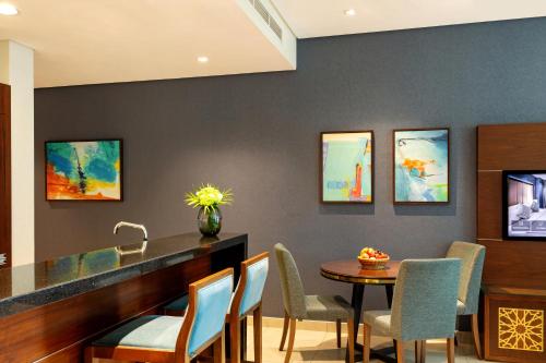 a dining room with a table and chairs at Royal Continental Suites Business Bay - Deluxe Apartments in Dubai