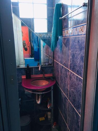 a bathroom with a red sink and a mirror at Casa da Barbie da Serra in Pacoti