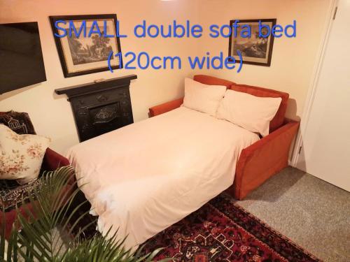 a small double sofa bed in a room at Charming Apartment near Kings Cross in London