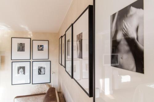 a living room with black and white pictures on the wall at Restaurant Hotel Merlet in Schoorl