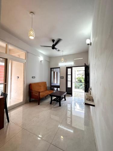 a living room with a couch and a ceiling fan at G 5 Gayathri Enclave 2 Bedroom Fully Furnished Apt in Trivandrum