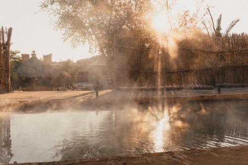 a fountain in the middle of a body of water at Stamps Ayur Siwa in Siwa