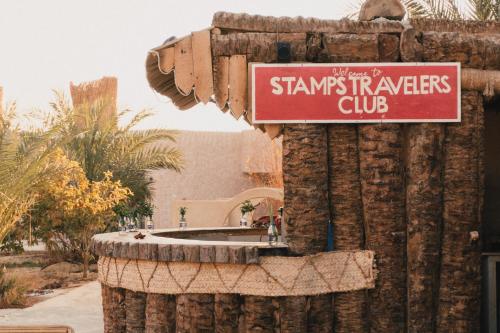 a sign that says stans therapies club on a building at Stamps Ayur Siwa in Siwa