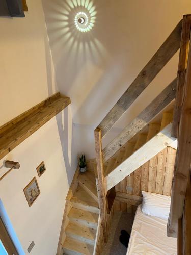 a room with a bunk bed and a staircase at Locanda al Toal in Moena