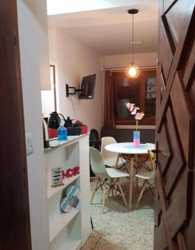 a room with a table and a dining room at Apto Av Beira Mar Capão da Canoa in Capão da Canoa