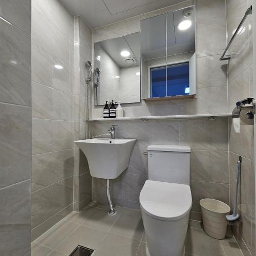 a bathroom with a white toilet and a sink at Namsan Rooftop in Seoul