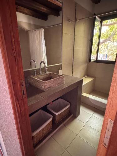 a bathroom with a sink and a bath tub at Chacras de Coria Casa del Descanso in Ciudad Lujan de Cuyo