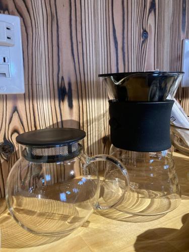two glass jars sitting on top of a table at 一軒宿 百々 private house rental doudou in Mitoyo