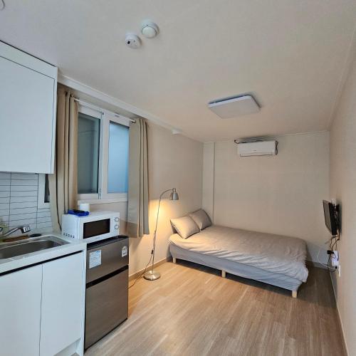a small room with a bed and a kitchen at Namsan Rooftop in Seoul