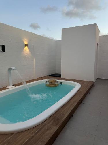 a bath tub with a fountain in a room at Casa Charme do Frencês in Marechal Deodoro