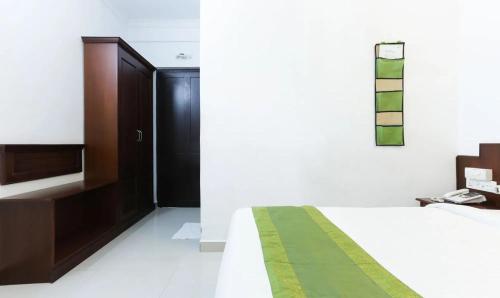 a bedroom with a bed and a black door at Hotel Centre Point in Cochin