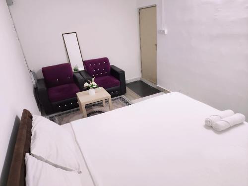 a bedroom with a bed and two chairs at separate entrance room in Al Ain