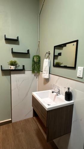 a bathroom with a sink and a mirror at Muy cerca de playas y miradores muy accesible a la ciudad y comercios in La Unión