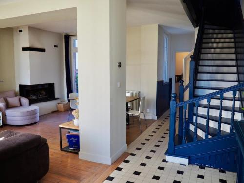 - un salon avec un escalier bleu dans une maison dans l'établissement Villa Primerose parking privé terrasse centre ville, à Le Touquet-Paris-Plage