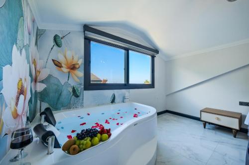 a bathroom with a tub with fruit in it at Villa Lotus/ Ölüdeniz Isıtmalı kapalı havuzlu in Fethiye